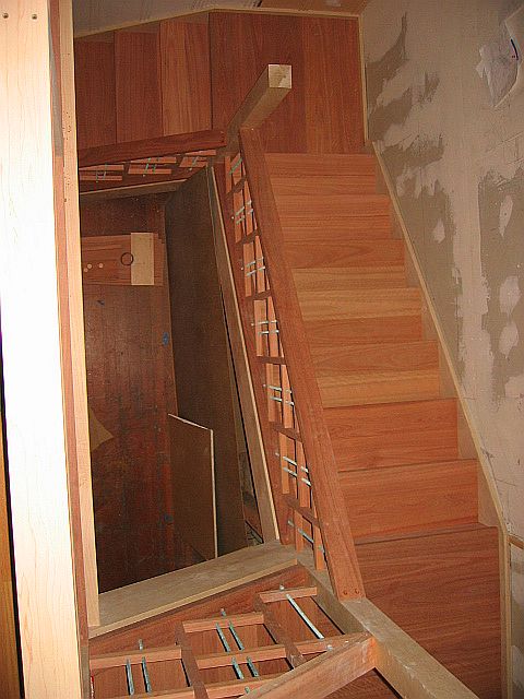 LIPTUS, MAPLE & METAL DOWEL STAIR & RAIL (downward view of the bottom flight, first landing, middle flight, second landing, posts & railing)
